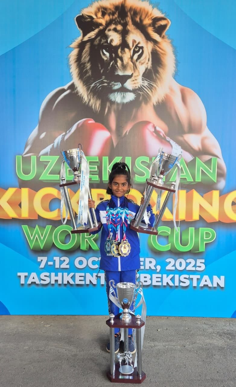 MMS student Rakshathra holding trophies at the Uzbekistan Kickboxing World Cup