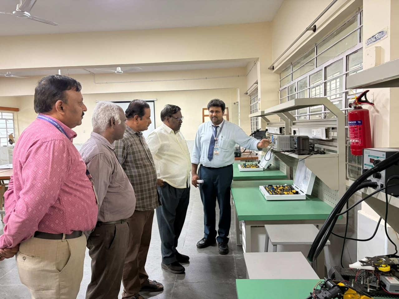 The MMS delegation on a guided tour of Adhiyamaan College of Engineering's electronics and robotics lab