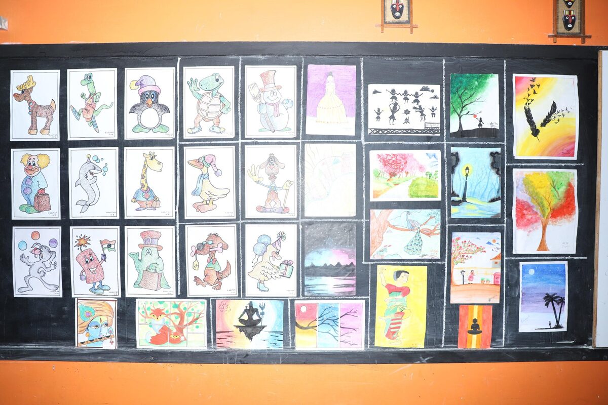 A display board filled with dozens of hand-drawn and coloured sketches