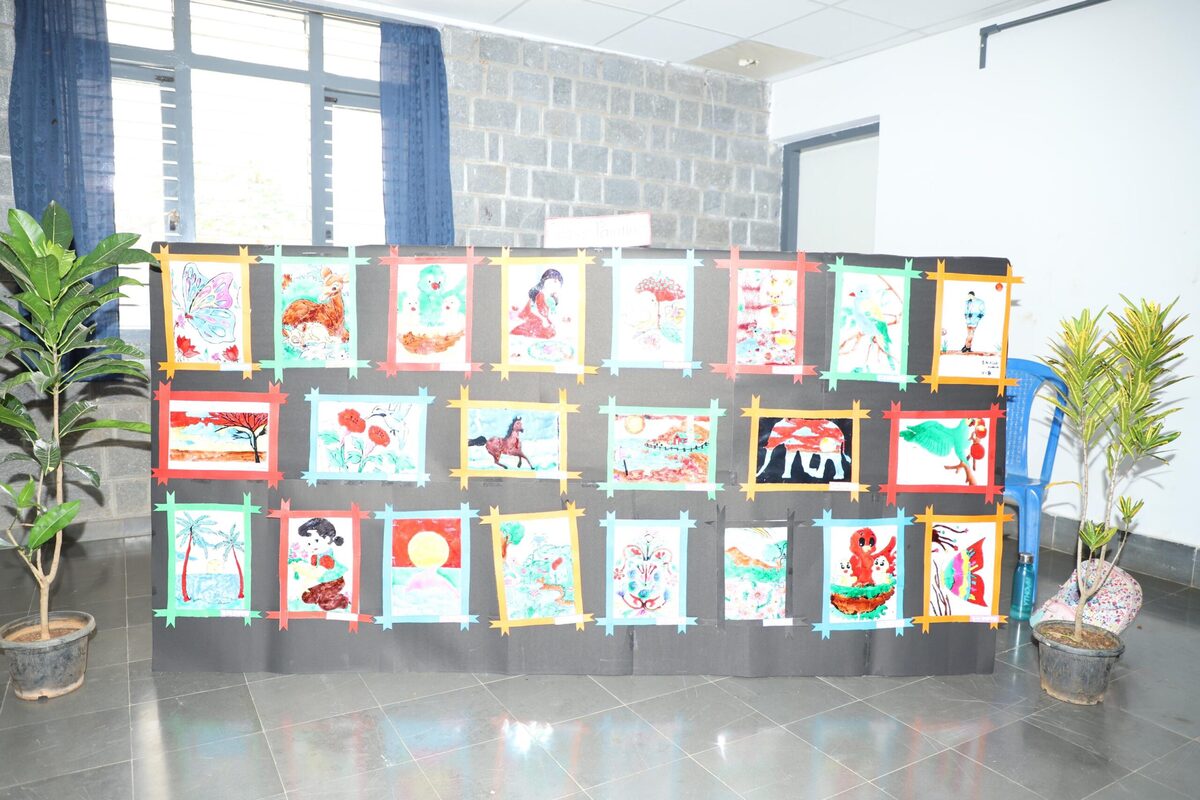 Student artwork exhibited on a display board in the school corridor