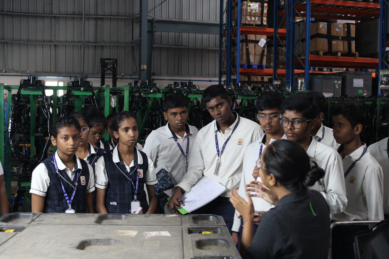 Students being briefed on component storage and logistics on the production floor