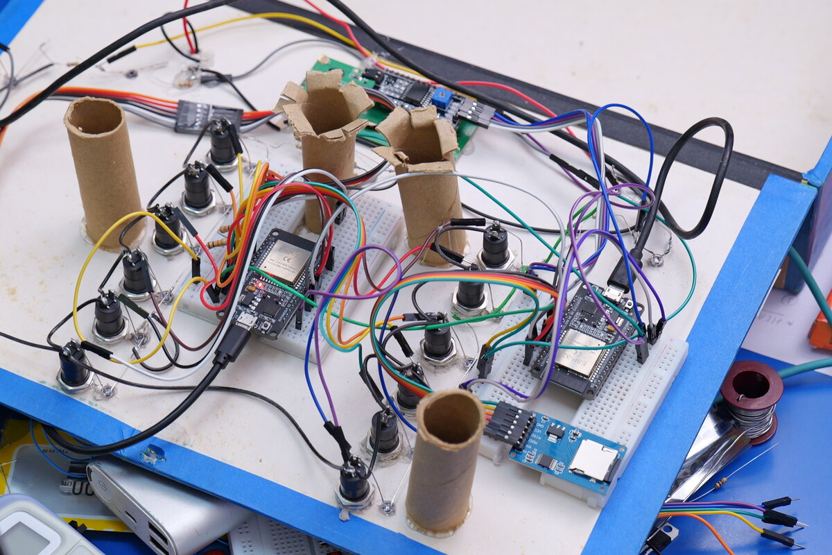 An early breadboard prototype built around an ESP32 microcontroller, with cardboard tube sensor mounts