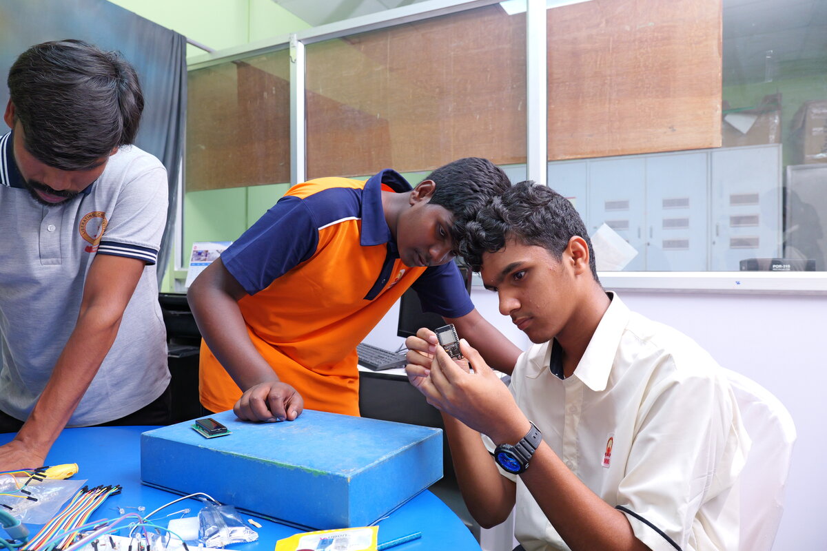 Two students inspecting an ESP32 board together