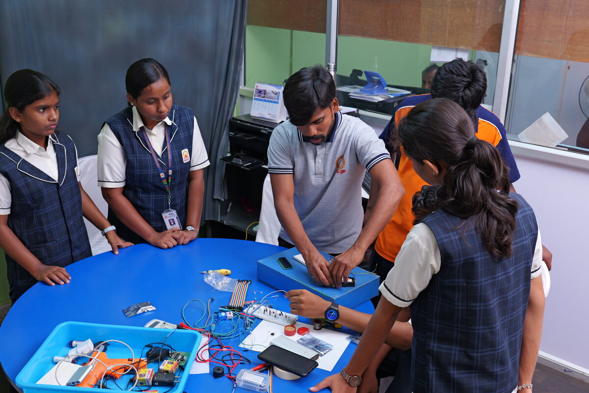 The whole team gathered around the workbench to test the build