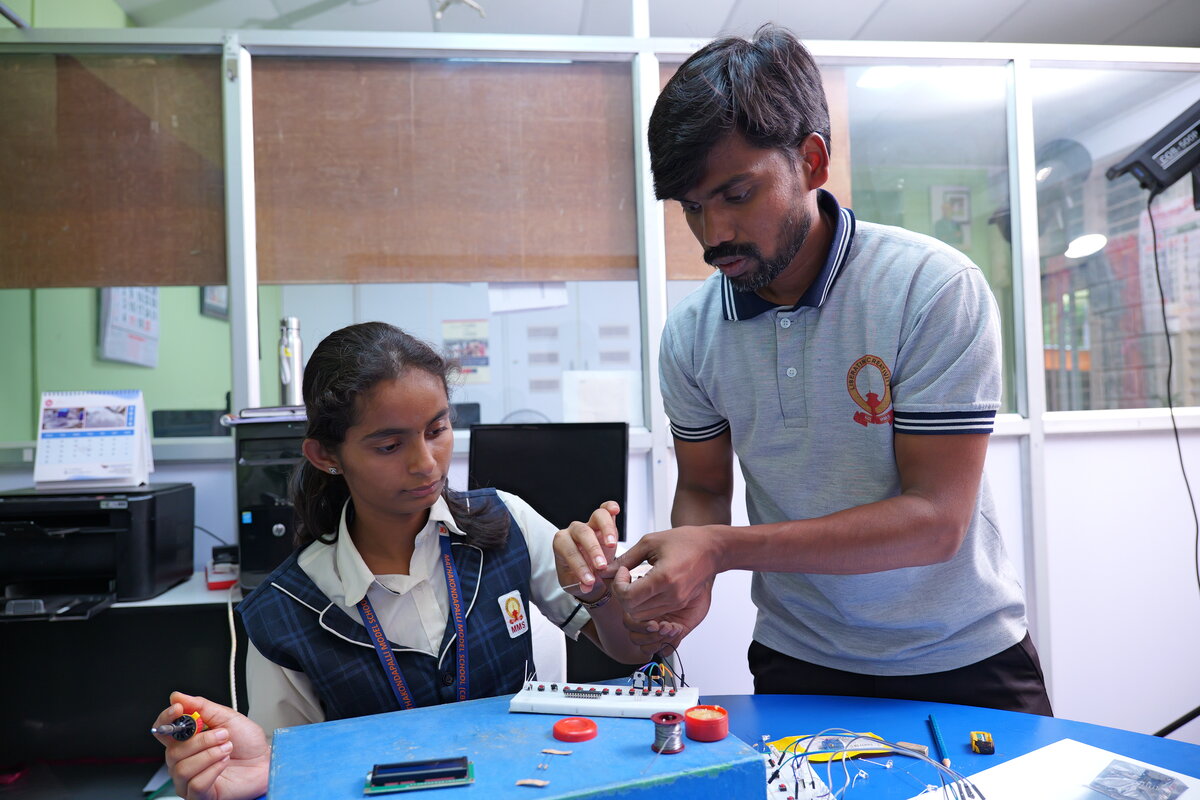 A mentor and student testing the circuit together