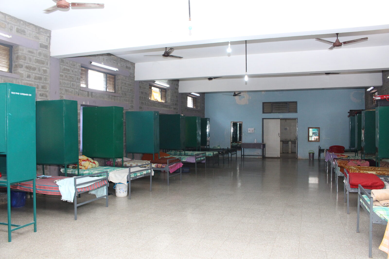 Hostel dormitory room with beds and cupboards