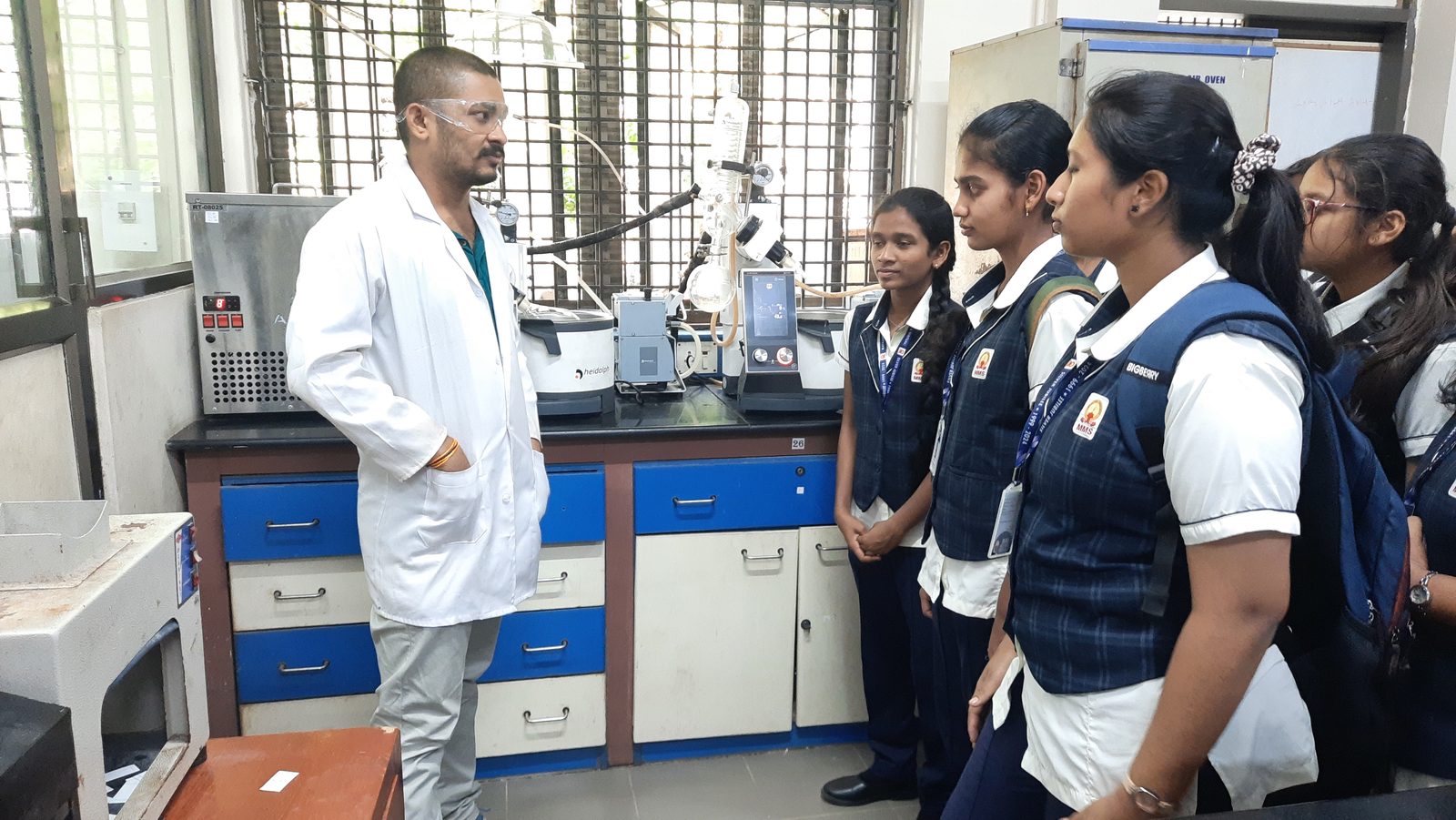 MMS students learning about laboratory equipment from an IIT Madras researcher