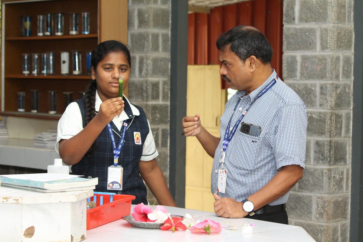 A student and teacher examining a biological specimen together