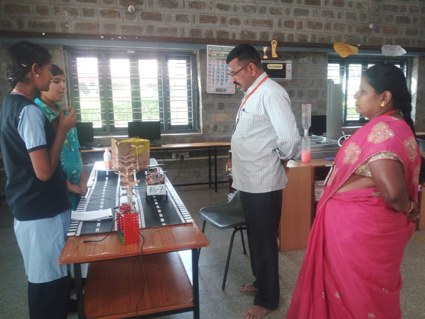 Students explaining the LiFi Road Safety model to staff