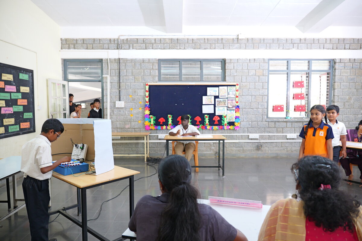Students queue to cast their vote at MMS Polling Booth 2, built around the student designed SEVS machine