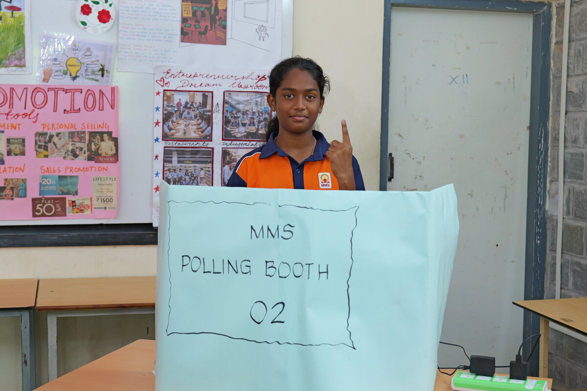 Candidates, polling officers and staff standing together at Polling Booth 2