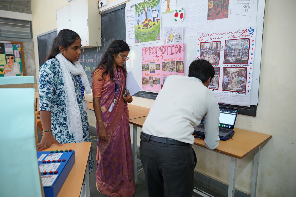 Teachers reviewing and tallying the votes on a laptop