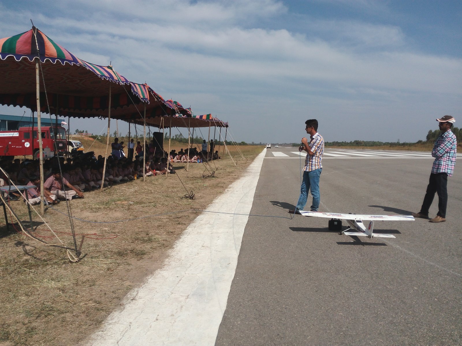 MMS students watching a model aircraft flying demonstration on the runway at TALL, Hosur Airdrome