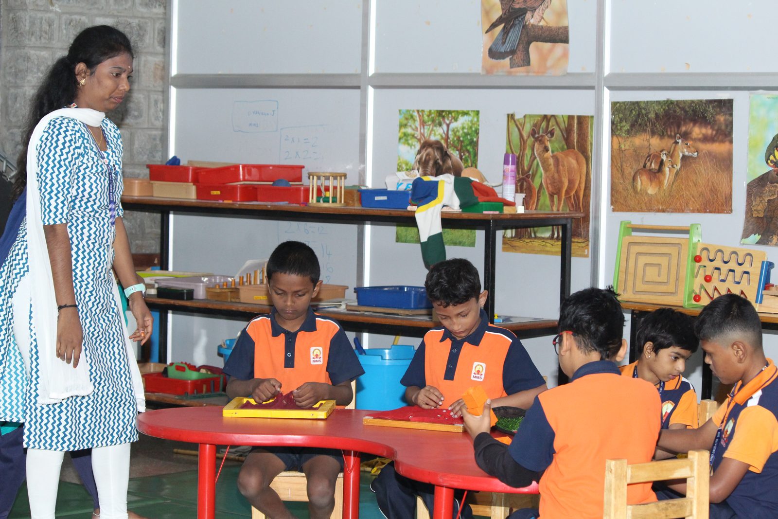 A special educator and a group of students working on activities at a table