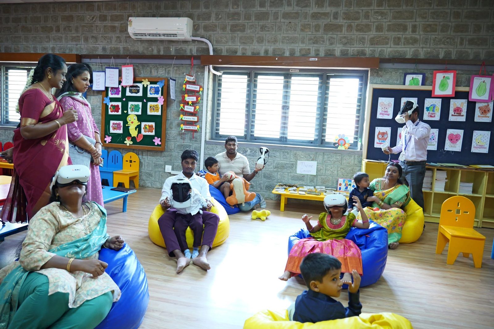 Families and children try VR headsets in the foundational stage classroom
