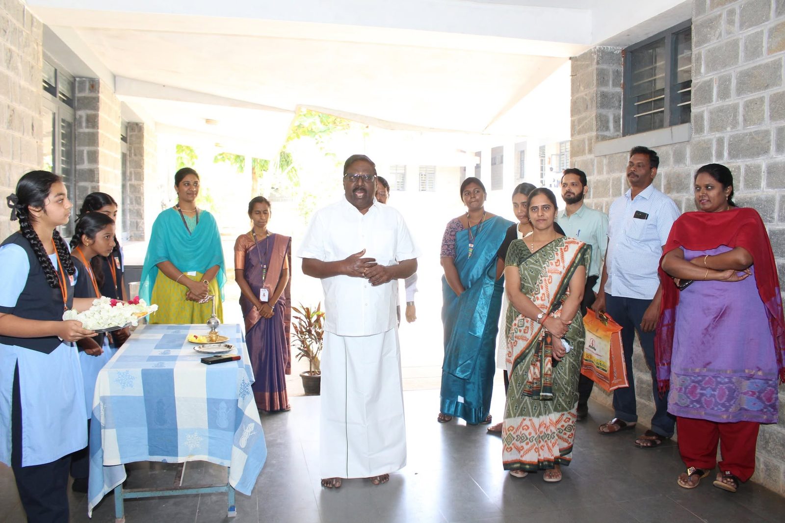 Staff and students welcoming a guest at the start of the inauguration
