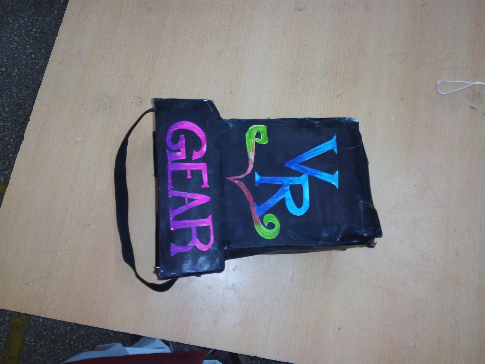 Homemade cardboard VR viewer built by MMS students, labelled GEAR VR